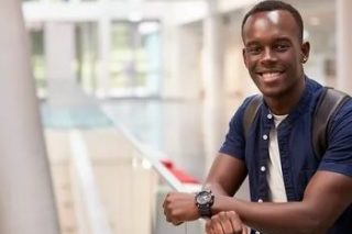 smiling-black-male-student-in-modern-uni